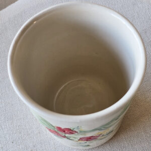 Porcelain cup with hand painted floral design.