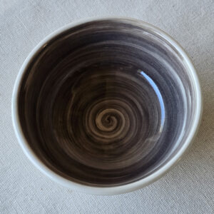 An unusual small bowl with strong contrasting colors black on the inside and white on the outside.