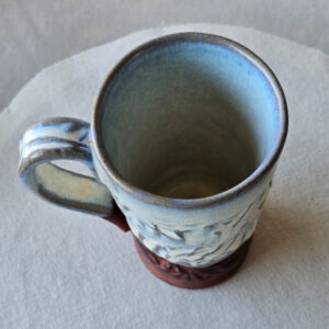 A beautiful opalescent colored mug with hints of blue floating through.