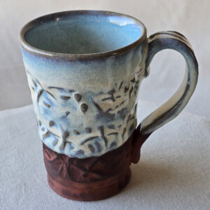 A beautiful opalescent colored mug with hints of blue floating through.