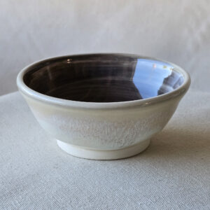 An unusual small bowl with strong contrasting colors black on the inside and white on the outside.