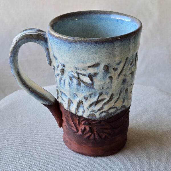 A beautiful opalescent colored mug with hints of blue floating through.